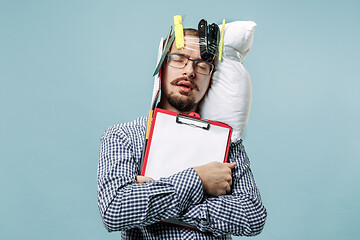 Image showing Tired man sleeping at home having too much work. Bored businessman with pillow