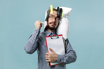 Image showing Tired man sleeping at home having too much work. Bored businessman with pillow