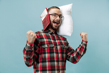 Image showing Tired man sleeping at home having too much work. Bored businessman with pillow