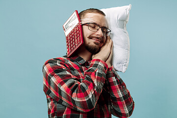 Image showing Tired man sleeping at home having too much work. Bored businessman with pillow