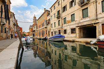 Image showing Venice, Italy. Tourists walking at sidewalks aside to canals in historic part of the city