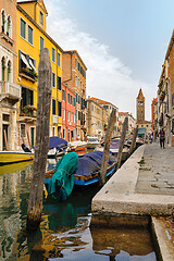 Image showing Venice, Italy. Tourists walking at sidewalks aside to canals in historic part of the city