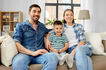 Image showing portrait of happy family sitting on sofa at home