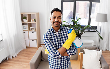 Image showing smiling indian man with detergent cleaning at home