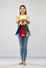 Image showing happy asian woman with shopping bags