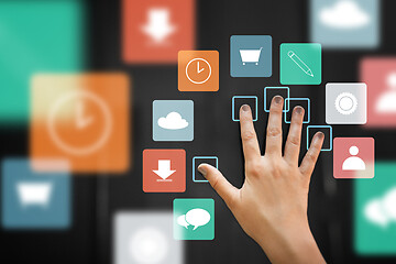 Image showing hand using interactive panel with app icons on it