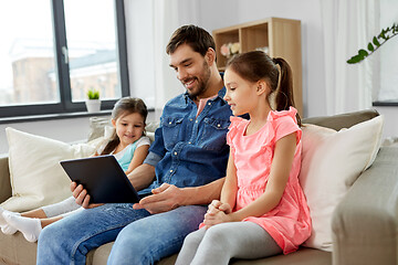 Image showing happy father and daughters with tablet pc at home