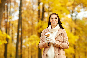 Image showing woman drinking takeaway coffee in autumn park