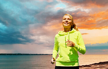 Image showing woman running over sea background