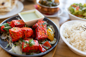 Image showing close up of paneer tikka dish with sauce on table