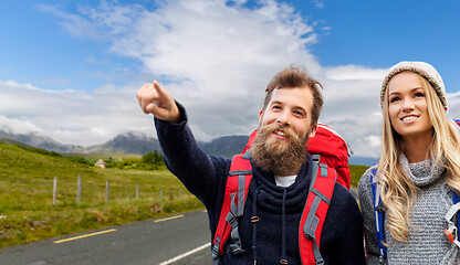 Image showing smiling couple with backpacks hiking in autumn