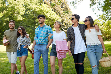 Image showing friends with guitar and picnic blanket at park