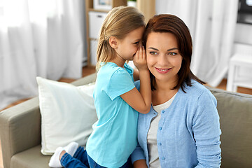 Image showing daughter whispering secret to mother at home