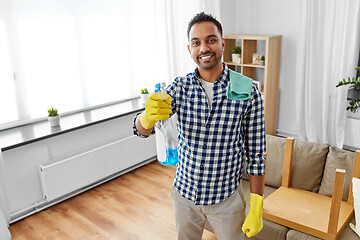 Image showing smiling indian man with detergent cleaning at home