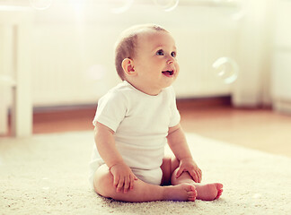 Image showing happy baby with soap bubbles at home