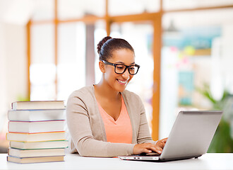 Image showing female student with laptop computer and books