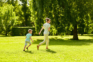 Image showing mother and son playing catch game at summer park
