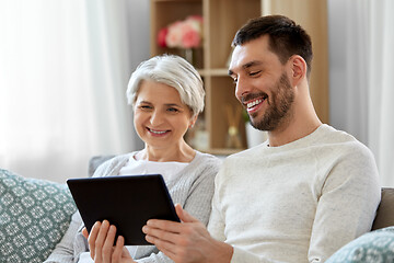 Image showing old mother and adult son with tablet pc at home