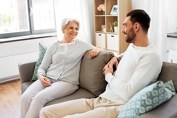 Image showing senior mother talking to adult son at home