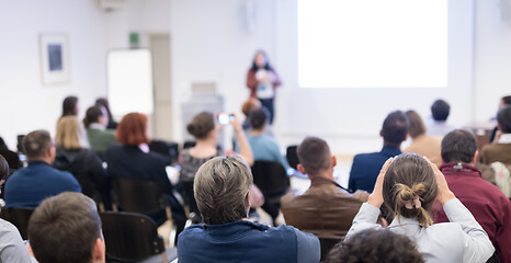 Image showing Woman giving presentation on business conference workshop.