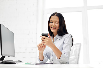 Image showing businesswoman using smartphone at office