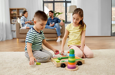 Image showing brother and sister playing toy blocks at home