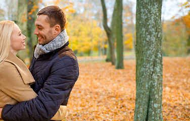 Image showing smiling couple hugging in autumn park