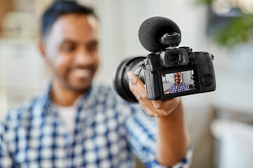 Image showing male video blogger with camera blogging at home