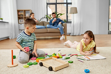 Image showing brother and sister playing and drawing at home