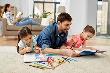 Image showing father spending time with little daughters at home