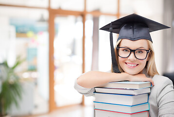 Image showing graduate student girl in bachelor hat with books