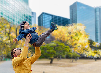 Image showing father with son having fun in autumn tokyo city