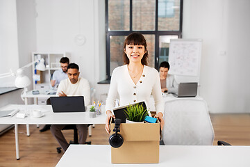 Image showing happy businesswoman with personal stuff at office