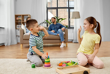 Image showing brother and sister playing toy blocks at home
