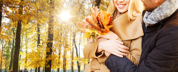 Image showing close up of smiling couple hugging in autumn park