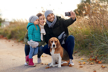 Image showing happy family with dog taking selfie in autumn