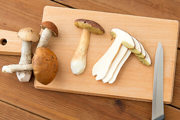 Image showing edible mushrooms, kitchen knife and cutting board