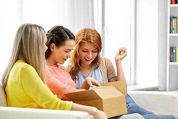 Image showing teenage girls or friends opening parcel box