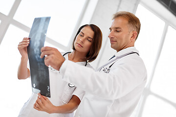 Image showing doctors with x-ray of spine at hospital