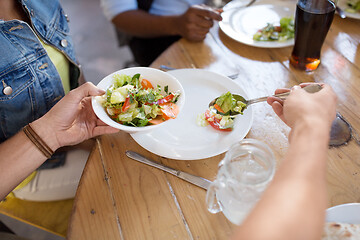 Image showing international friends eating at restaurant