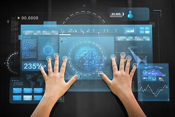 Image showing hand using black interactive panel with charts