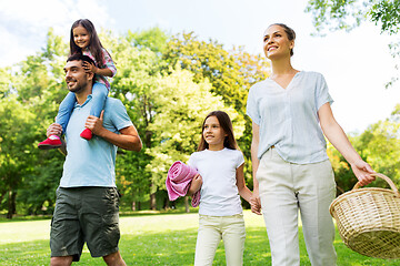 Image showing family with picnic basket walking in summer park