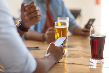 Image showing man with smartphone drinking beer at bar or pub