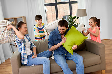 Image showing happy family having pillow fight at home