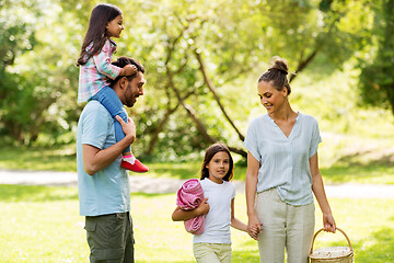 Image showing happy family with picnic basket in summer park