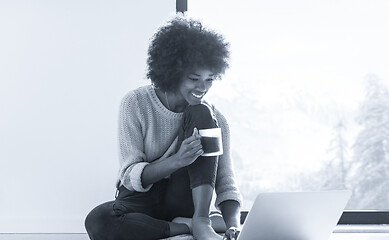 Image showing black woman in the living room on the floor