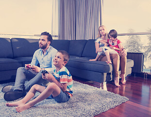 Image showing Happy family playing a video game