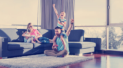 Image showing Happy family playing a video game