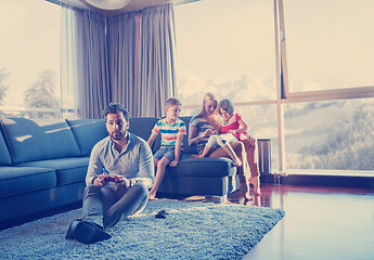 Image showing Happy family playing a video game