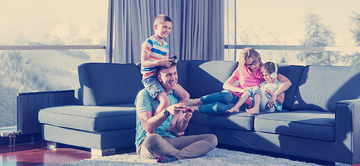 Image showing Happy family playing a video game